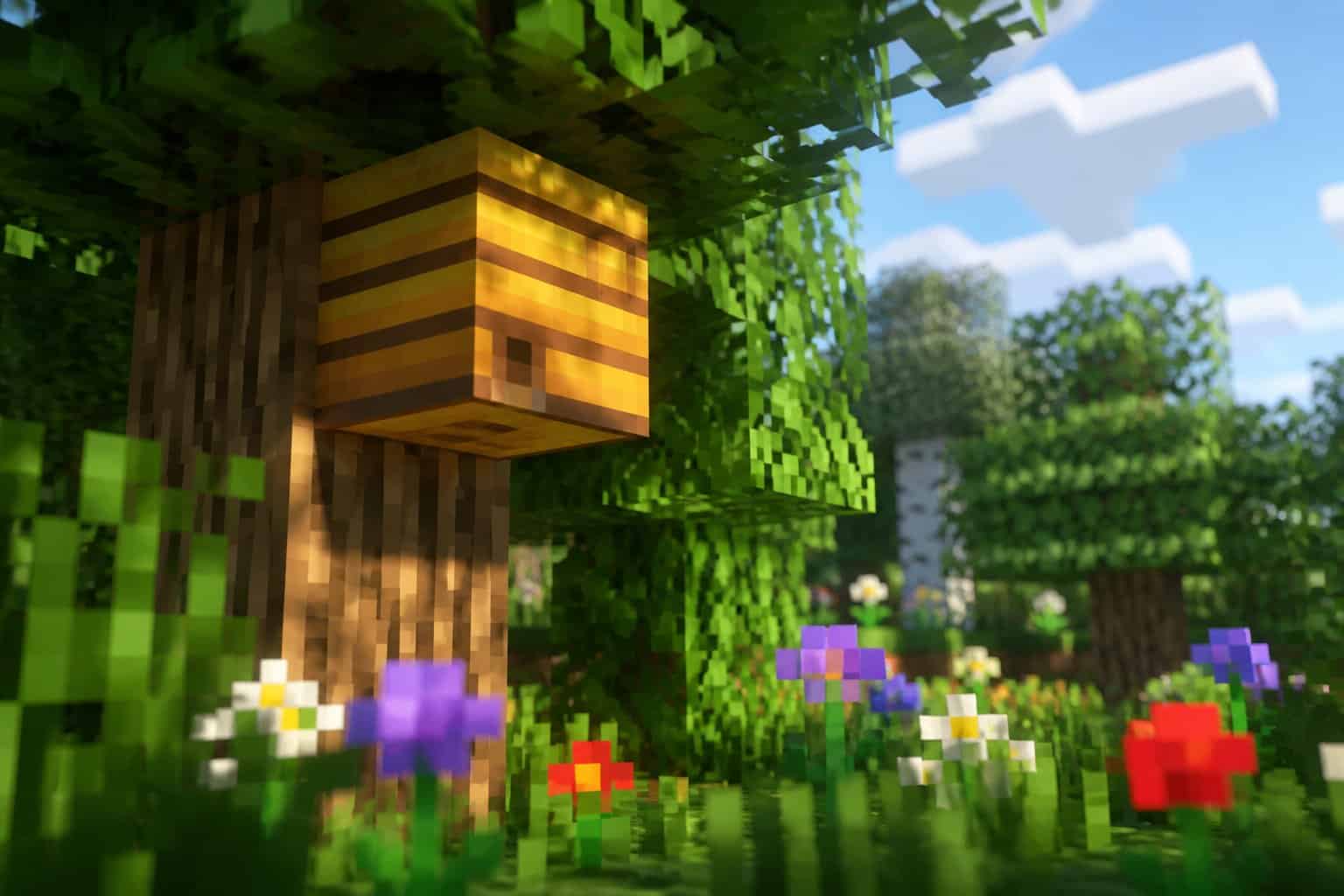 Close-up of a Minecraft-style beehive on a tree with flowers nearby but no bees flying around.